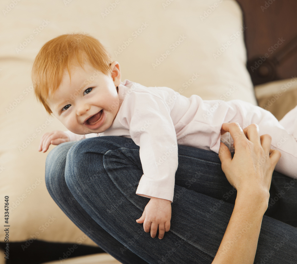 Caucasian mother playing with baby daughter Caucasian mother playing with baby daughter