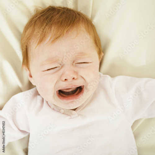 Crying Caucasian baby girl photo