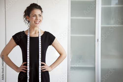 Businesswoman with measuring tape around her neck