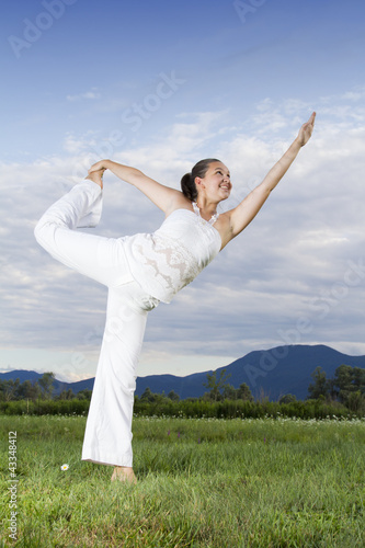 Young brunette girl performing yoga