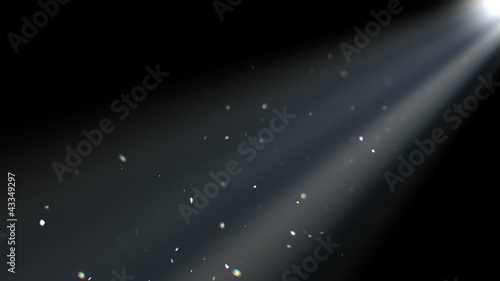 Specks of dust floating a beam of light. photo
