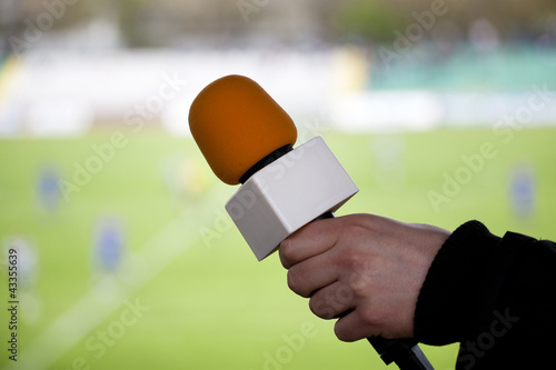 Foto hand hold microphone for  interview during a football mach