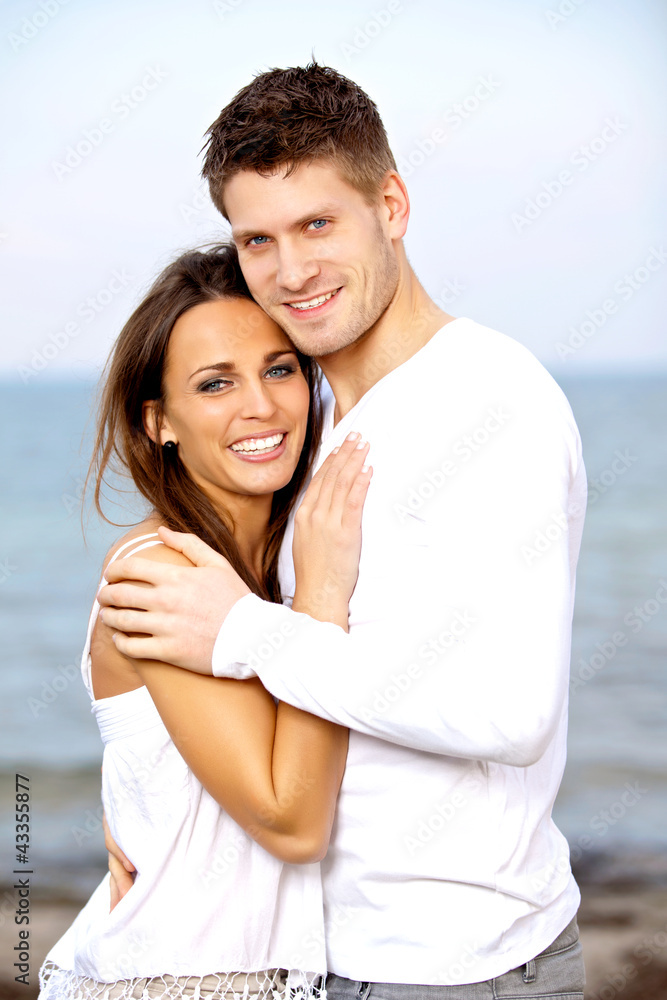 Lovely Young Couple Smiling while Posing Lovely Young Couple Smiling while Posing