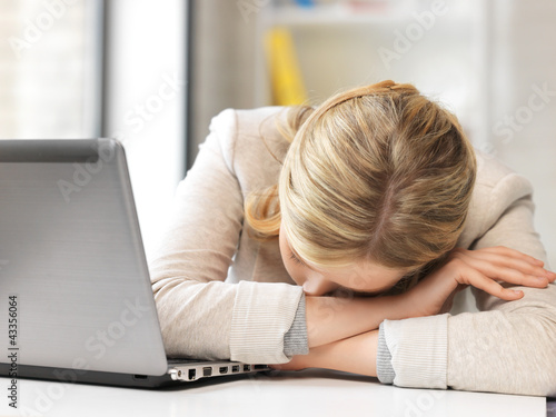 tired woman with laptop computer photo