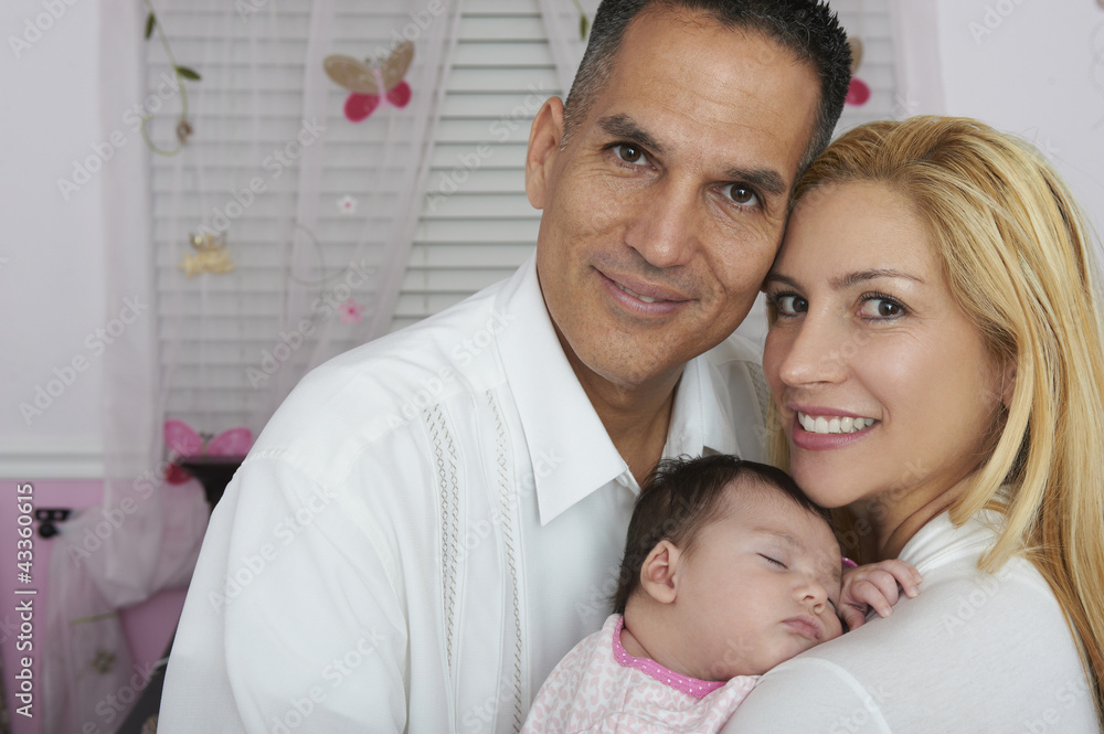 Hispanic parents holding baby daughter Hispanic parents holding baby daughter