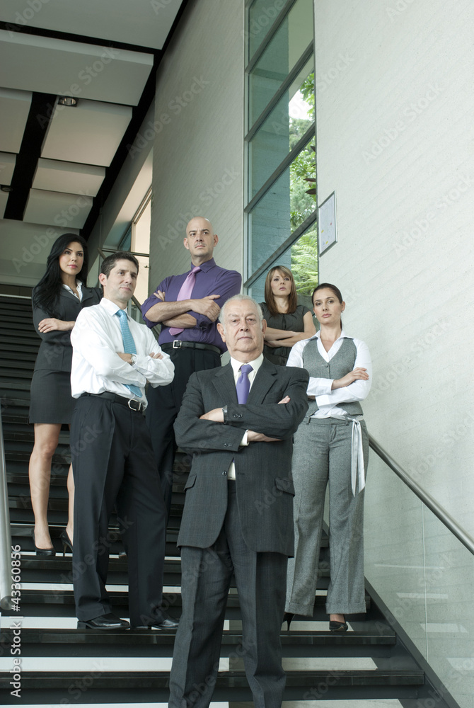 Hispanic business people standing together on staircase