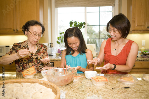 Multi-generation Chinese family cooking together photo