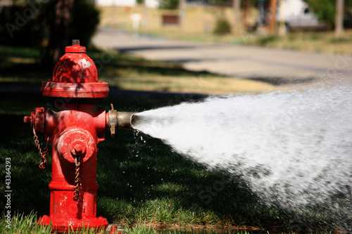 Open Fire Hydrant Spraying High Pressure Water photo
