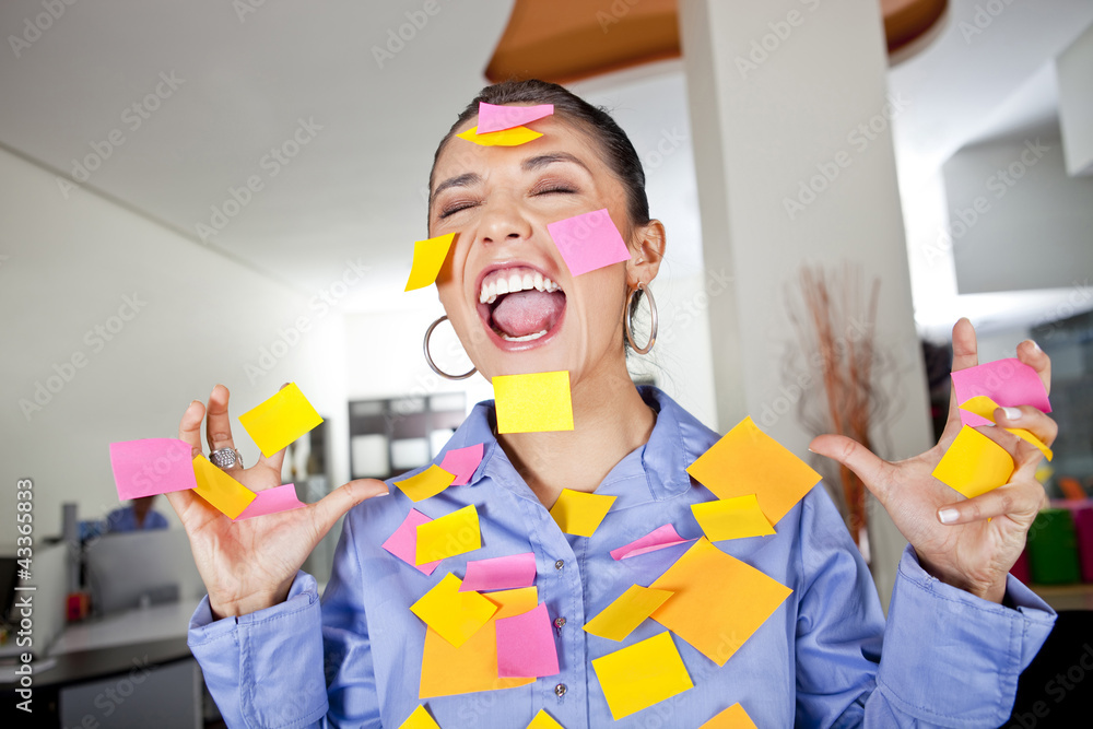 Hispanic businesswoman covered in sticky notes Hispanic businesswoman covered in sticky notes