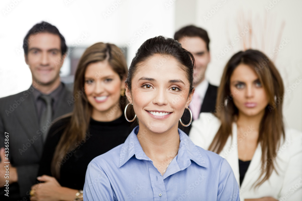 Hispanic business people standing together in office Hispanic business people standing together in office
