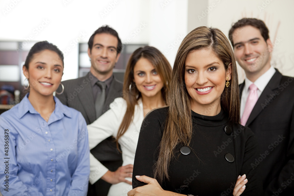 Hispanic business people standing together in office Hispanic business people standing together in office