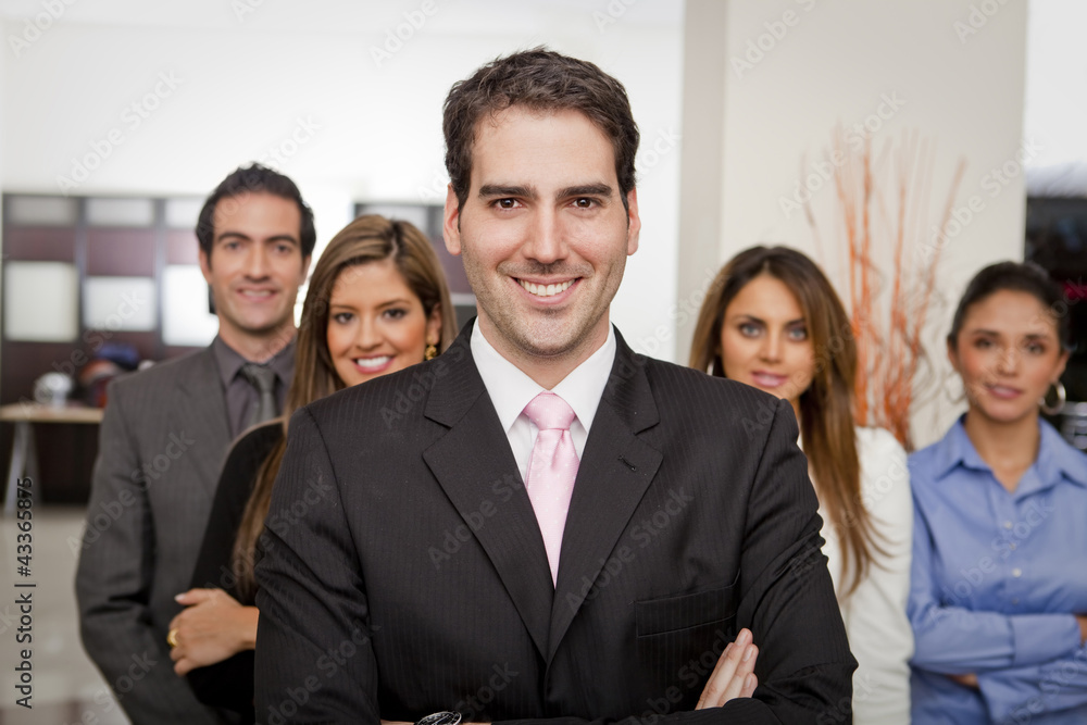 Hispanic business people standing together in office Hispanic business people standing together in office