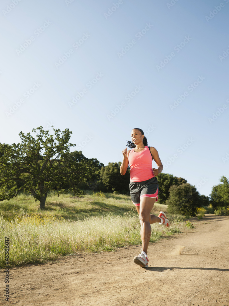 Black woman running on remote trail Black woman running on remote trail