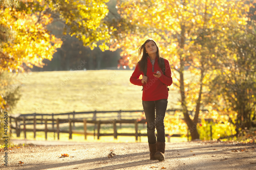 Caucasian girl walking on road in countryside Caucasian girl walking on road in countryside