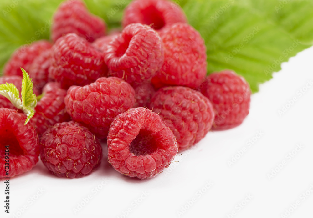 raspberries with leaves isolated on white background raspberries with leaves isolated on white background