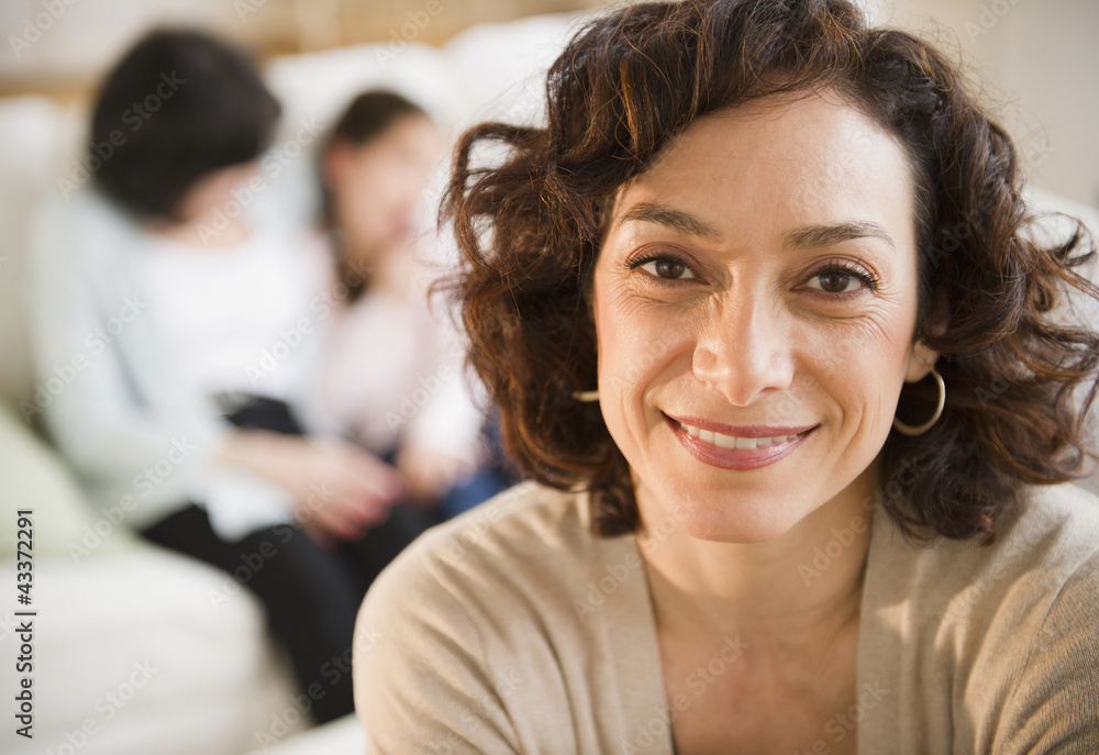 Smiling woman with family in background Smiling woman with family in background