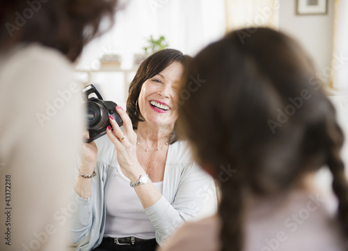 Woman taking picture of daughter and granddaughter photo