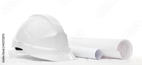 White hard hat near working or engineering drawings