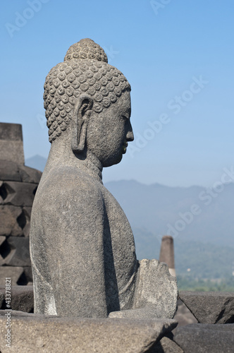 Buddha statue. Mountain on background. Borobudur. Java. Indonesi photo