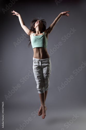 beauty girl dance on grey background