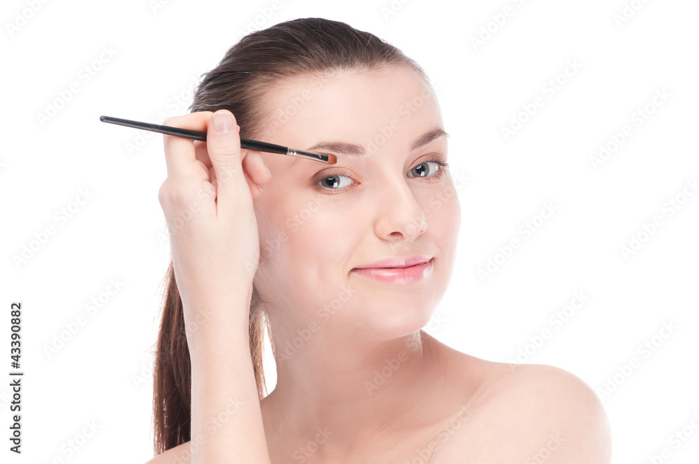 Beautiful woman with make up brush