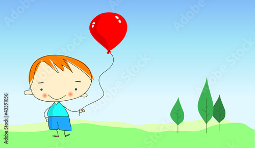 happy boy on green gras with red inflatable balloon