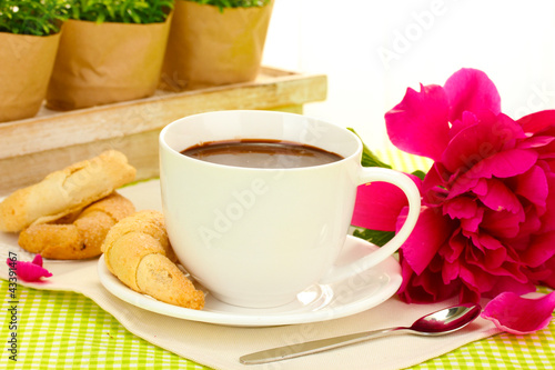 cup hot chocolate  cookies  and flower on table in cafe