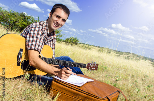 Traveling artist writes a song in nature