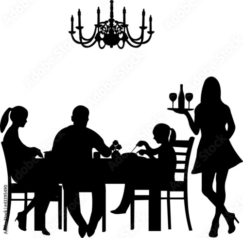 Silhouette of a restaurant  were a family enjoy their dinner