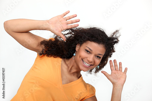 Young woman holding her hands up