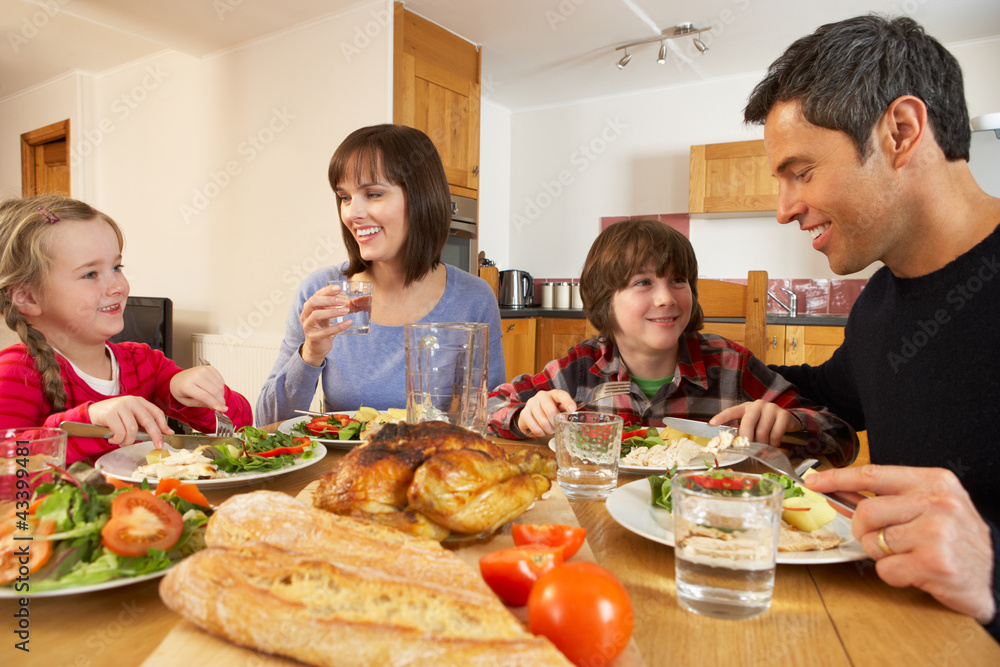 Family Eating Lunch Together In Kitchen