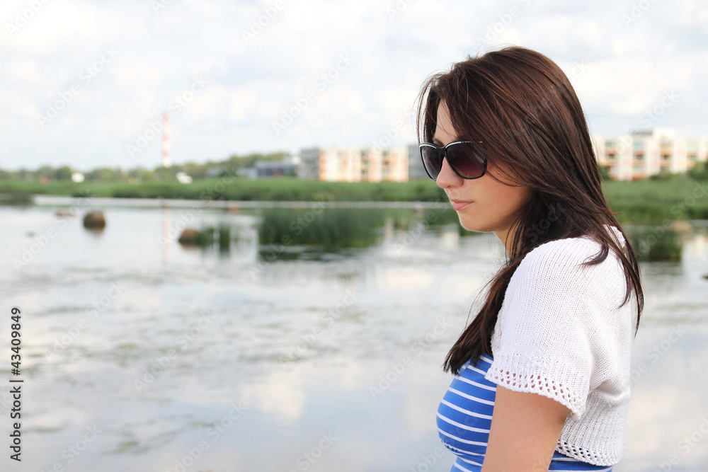 young beautiful smiling female near the lake young beautiful smiling female near the lake