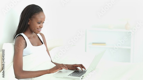 Woman typing on her wireless computer photo