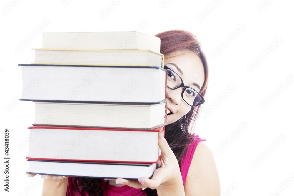 College student smiling behind books College student smiling behind books