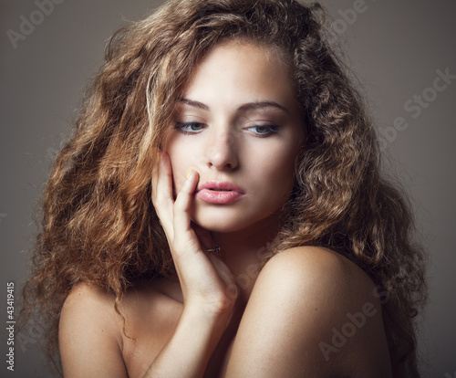 Beautiful young woman with gorgeous curly hair photo