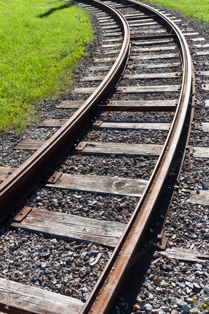 Railway rail road track disappearing around a curve Railway rail road track disappearing around a curve