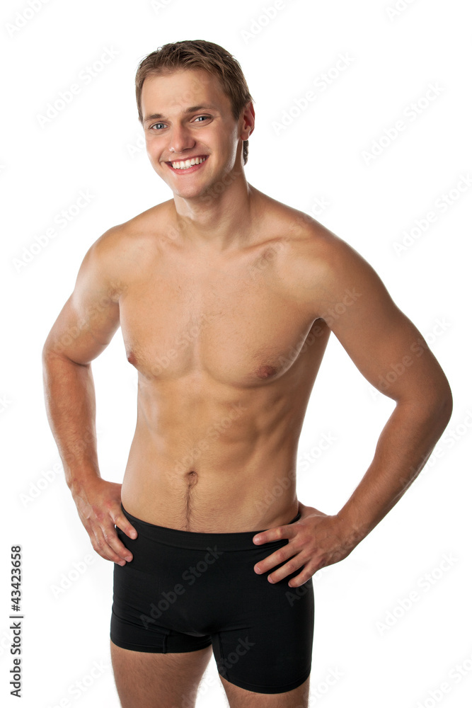 Cheerful young man in trunks over white background Cheerful young man in trunks over white background