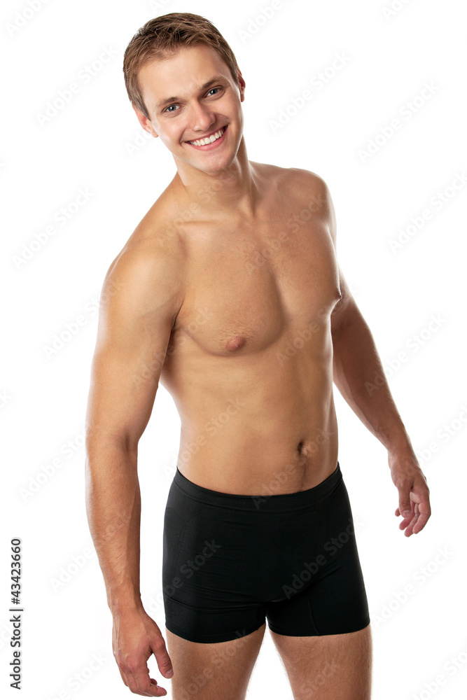 Cheerful young man in trunks over white background Cheerful young man in trunks over white background