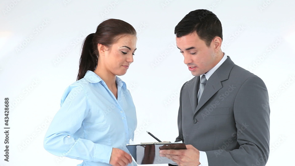 Business people signing a contract on a clipboard Business people signing a contract on a clipboard