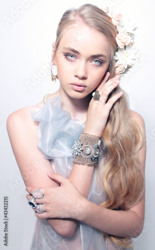 Portrait of beautiful young teenager girl in jewelery weared blu photo