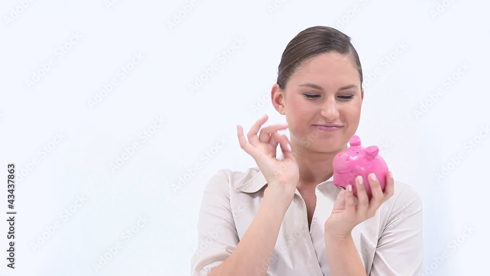Businesswoman holding a piggy bank Businesswoman holding a piggy bank