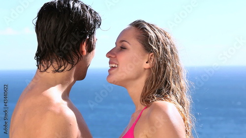 Couple kissing next to the sea