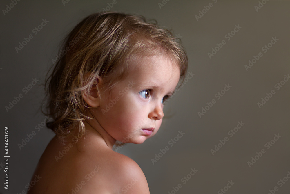 Adorable two-year old baby thinks of something serious Adorable two-year old baby thinks of something serious