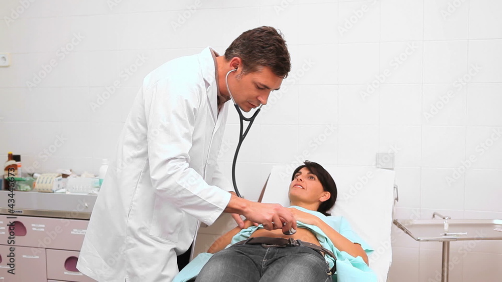 Doctor auscultating patient belly with a stethoscope Doctor auscultating patient belly with a stethoscope