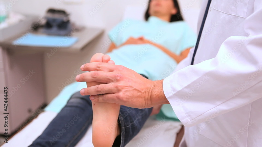Doctor manipulating foot of a patient Doctor manipulating foot of a patient