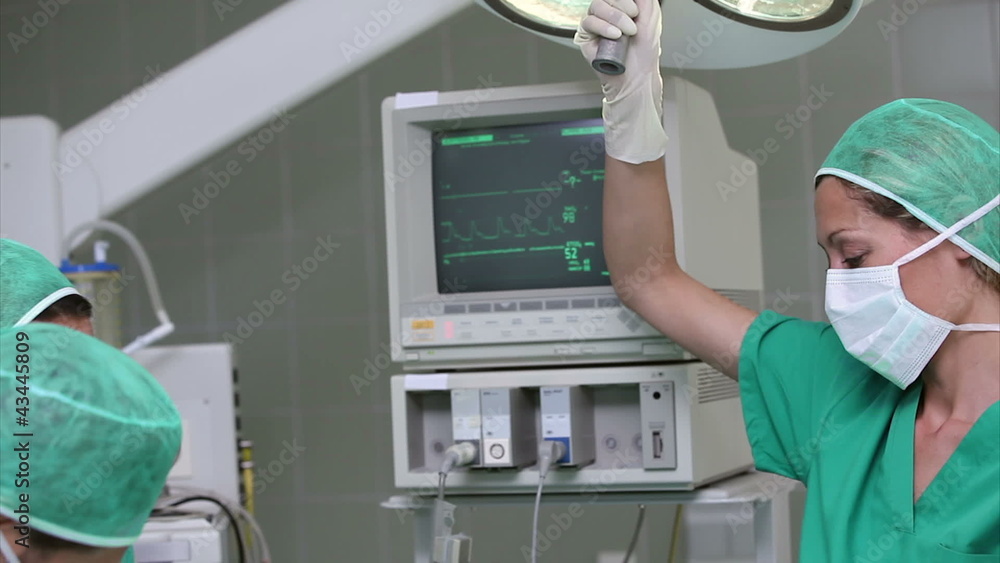 Serious doctors operating a surgical tools Serious doctors operating a surgical tools