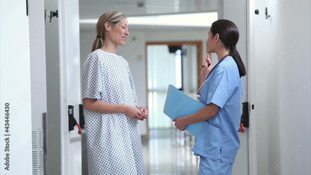 Nurse walking with a patient in a hospital Nurse walking with a patient in a hospital