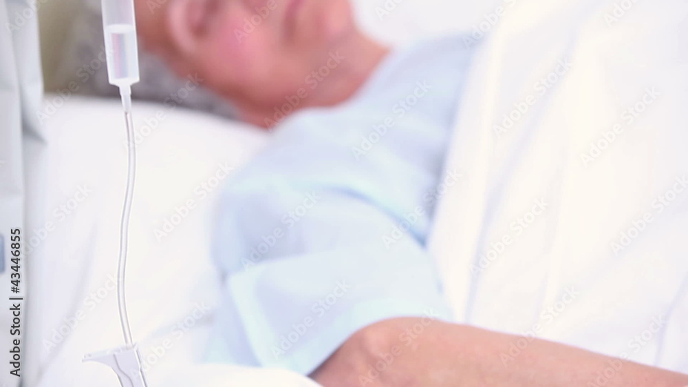 Elderly patient sleeping on a medical bed Elderly patient sleeping on a medical bed