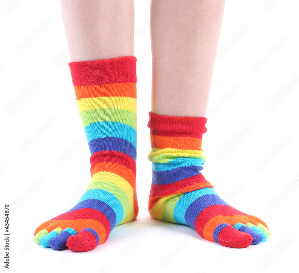 female legs in colorful striped socks isolated on white female legs in colorful striped socks isolated on white