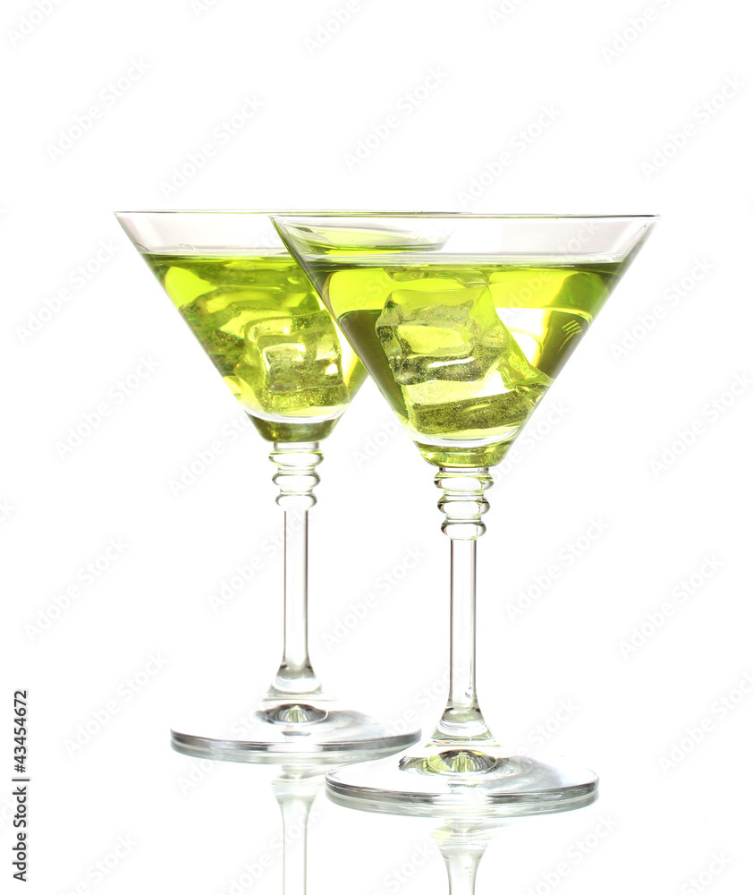 Yellow cocktail in martini glasses isolated on white Yellow cocktail in martini glasses isolated on white